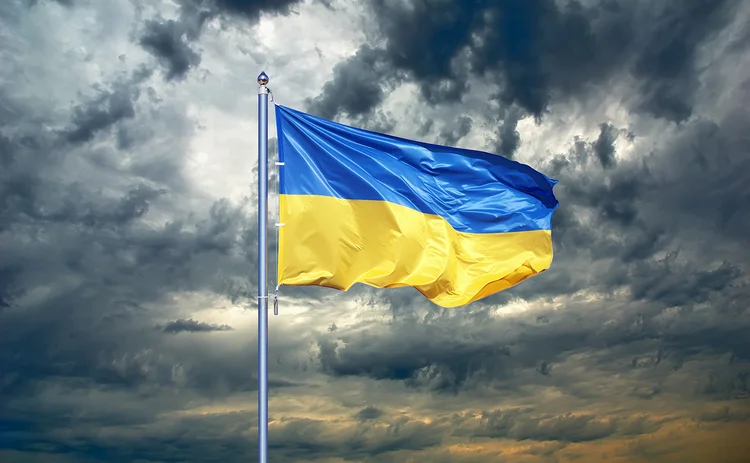 Ukraine flag on dark cloud background